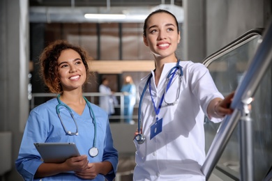 Photo of Happy medical students in modern college hallway