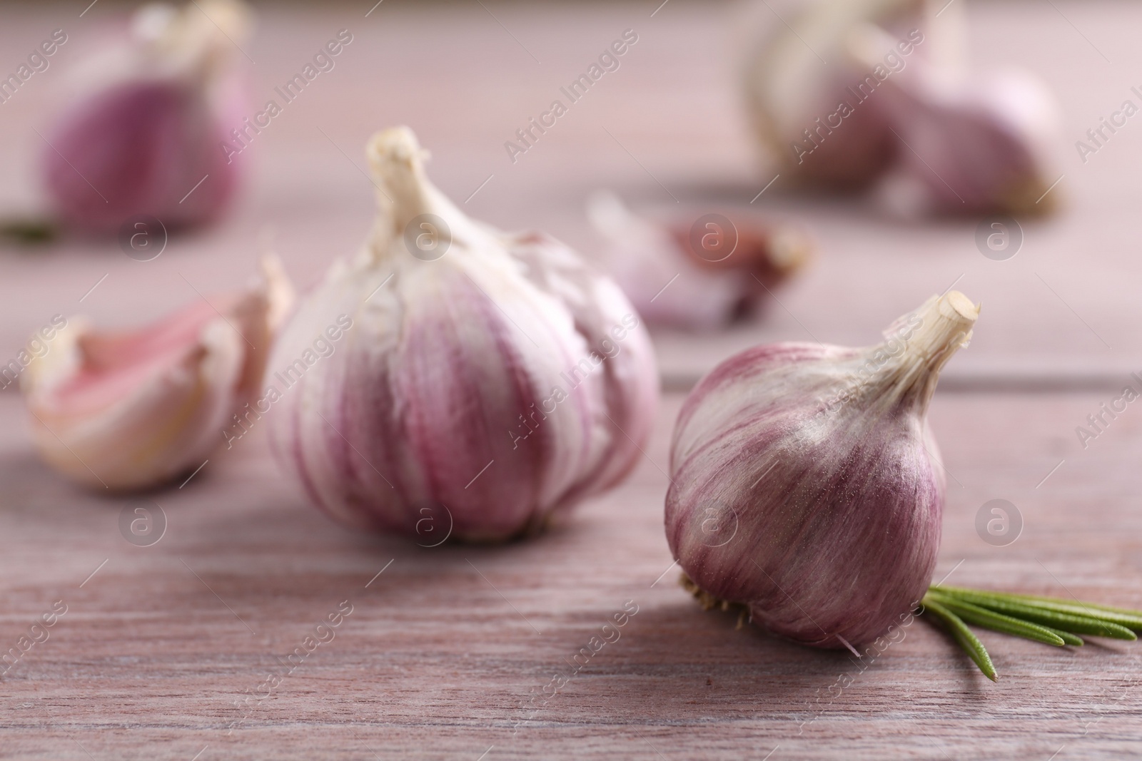 Photo of Bulbs of fresh garlic on wooden table, selective focus