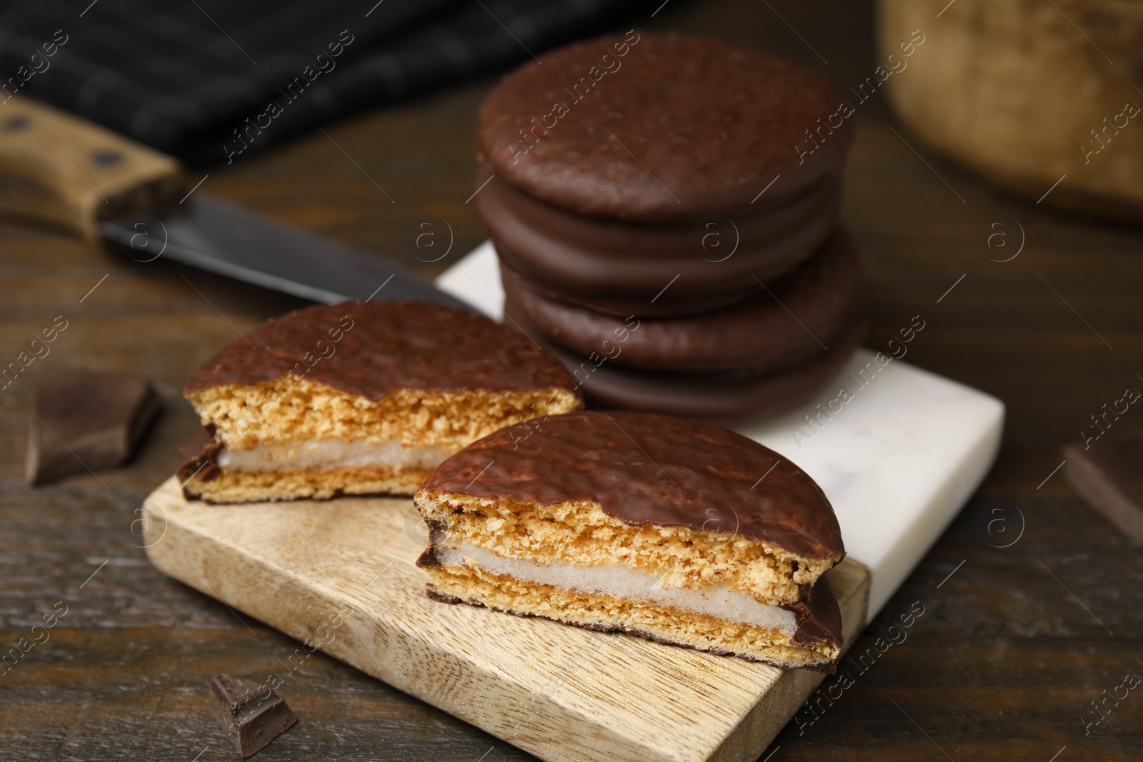 Photo of Tasty choco pies on wooden table, closeup