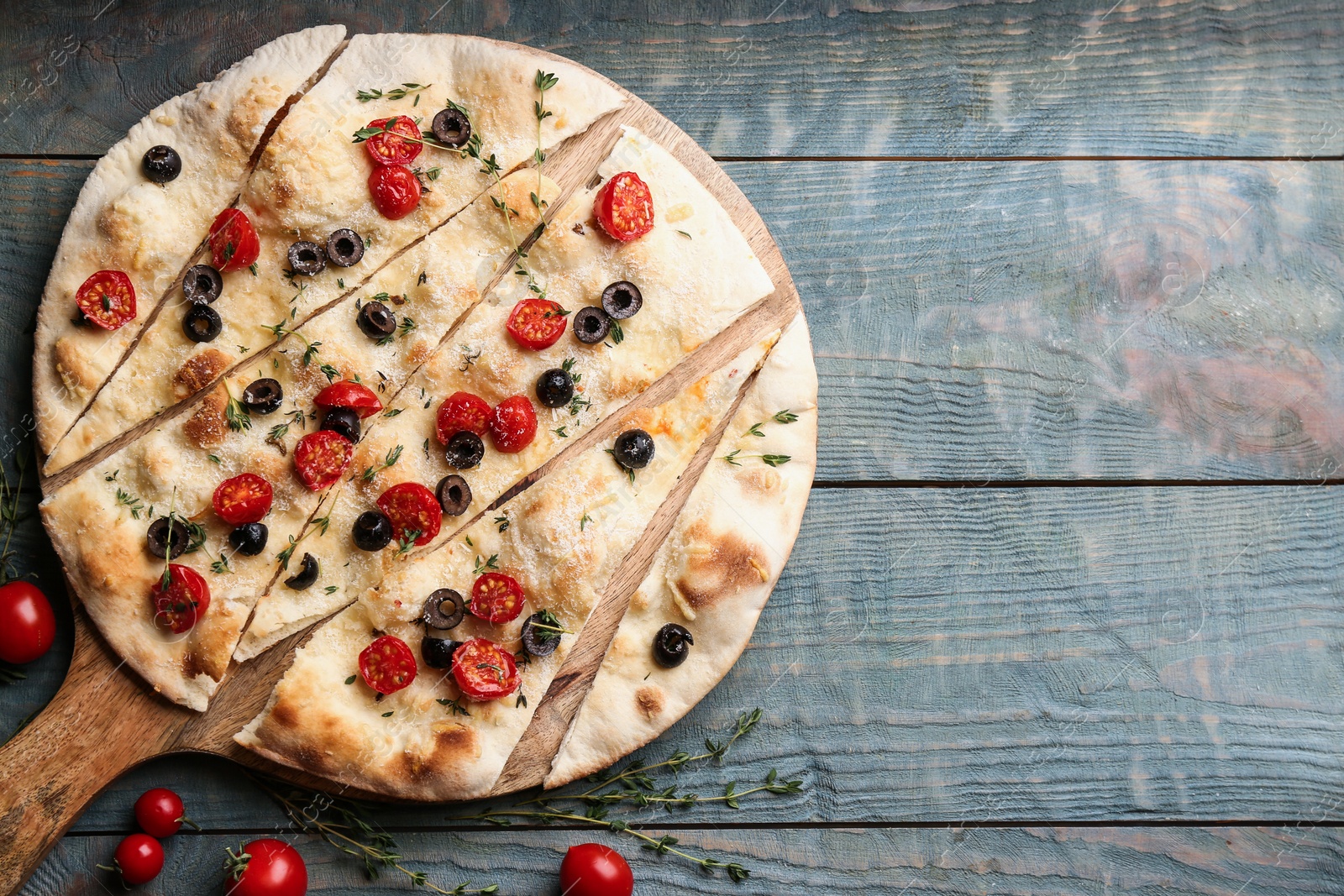 Photo of Flat lay composition with focaccia bread on blue wooden table. Space for text