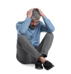 Photo of Mature businessman in stylish clothes sitting on white background