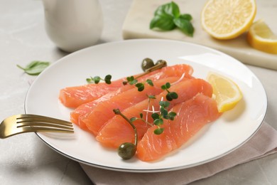 Delicious salmon carpaccio served on light grey table, closeup