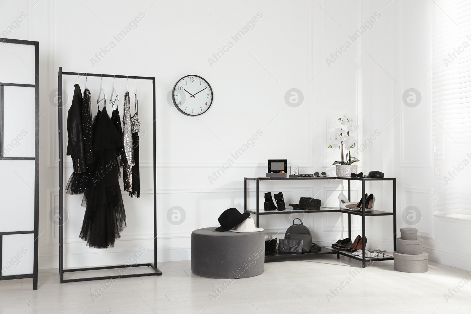 Photo of Stylish dressing room interior with trendy clothes, shoes and accessories