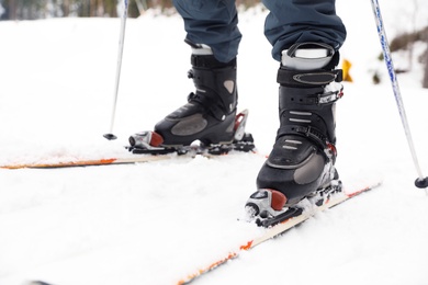 Photo of Skier on slope at resort, closeup. Winter vacation