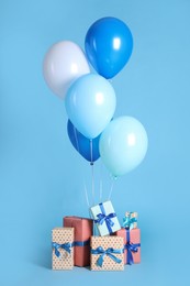 Photo of Many gift boxes and balloons on light blue background