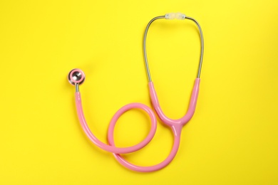 Photo of Stethoscope on color background, top view. Medical tool