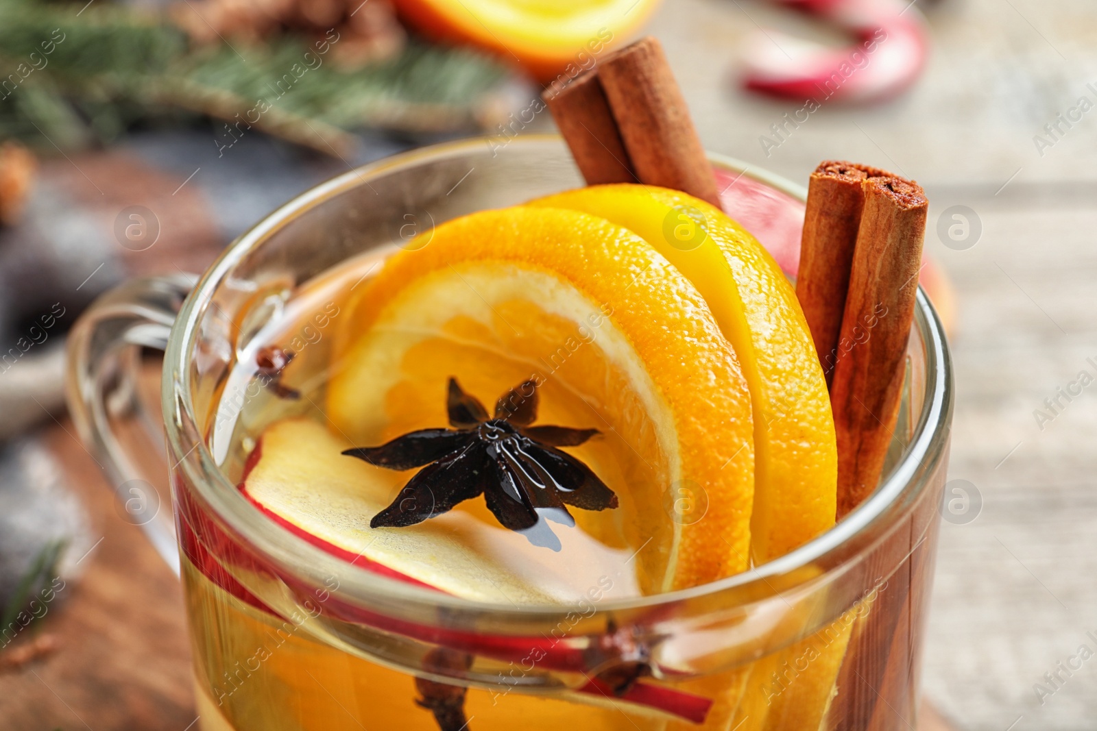 Photo of Delicious aromatic mulled wine on table, closeup