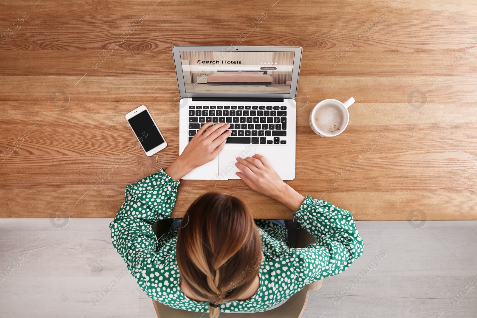 Image of Woman searching hotel using laptop at table, top view. Booking online service