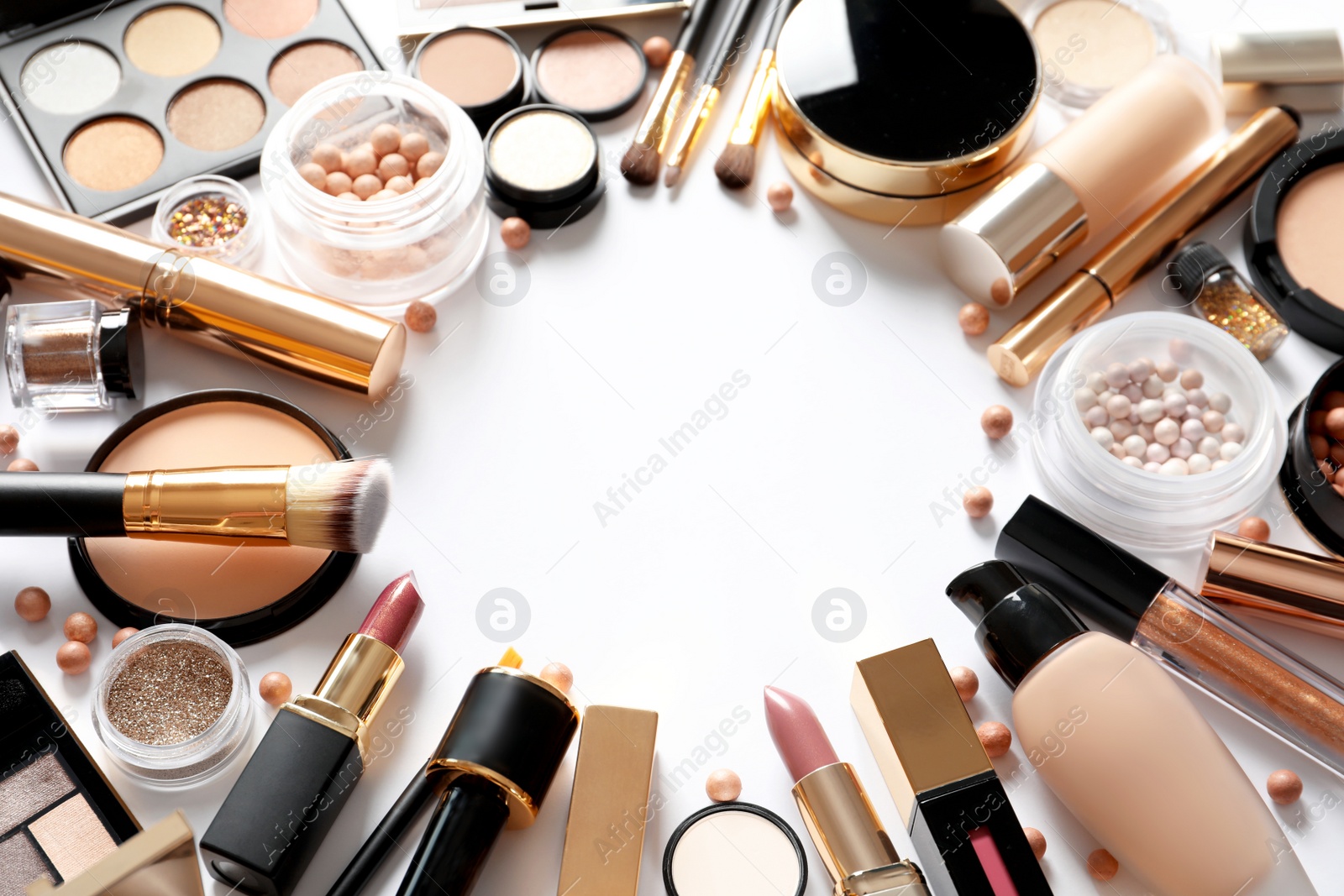 Photo of Frame made of different luxury makeup products on white background. Space for text