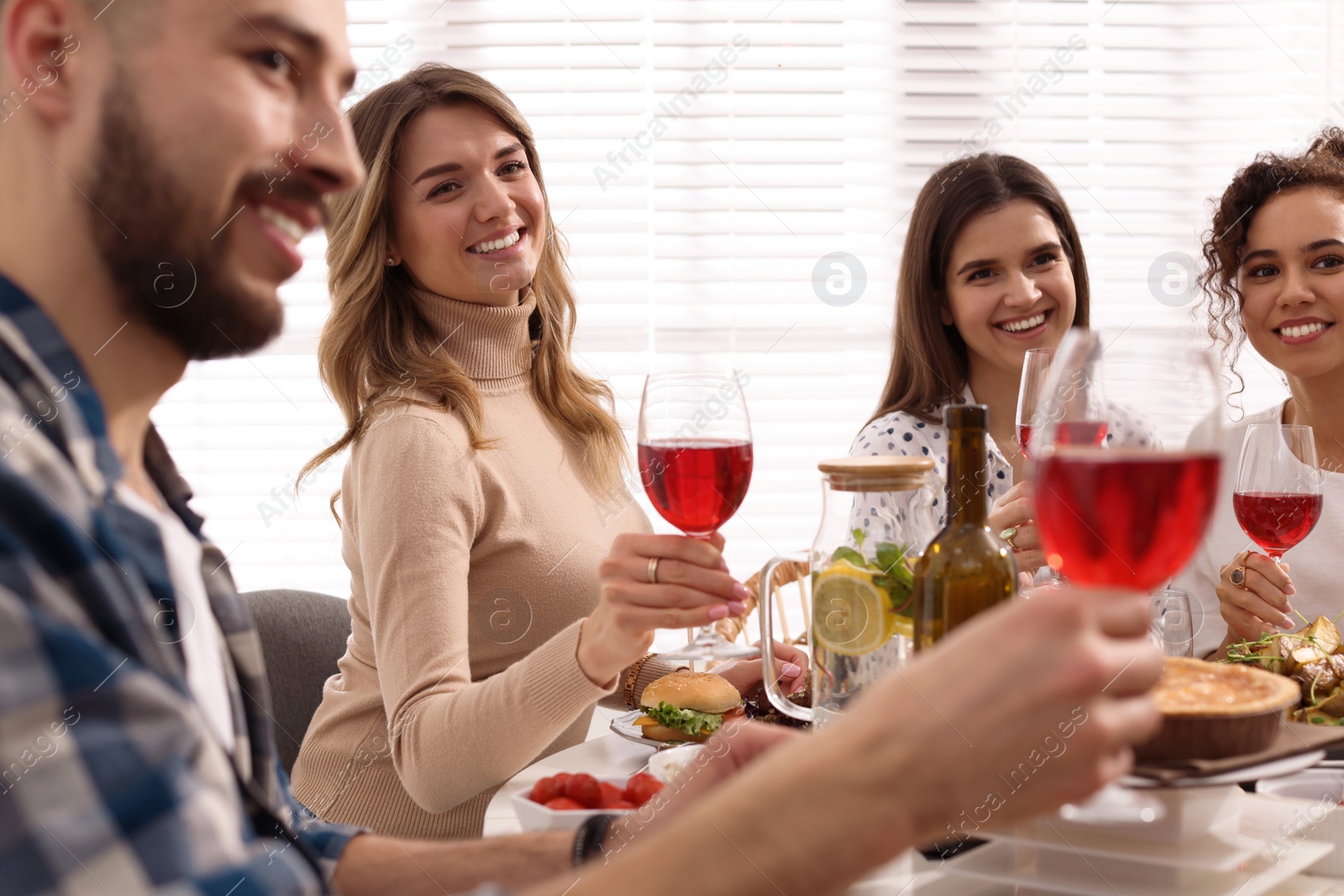 Photo of Group of people having brunch together at table indoors