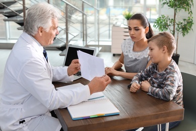 Photo of Little boy passing test at child psychologist office