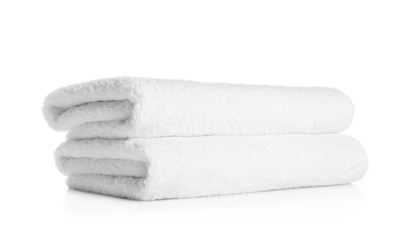 Photo of Stack of clean soft towels on white background