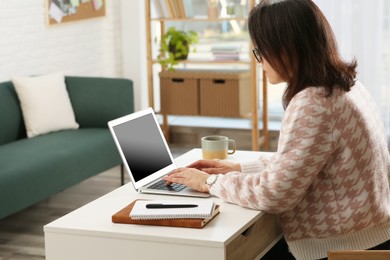 Woman with modern laptop learning at home