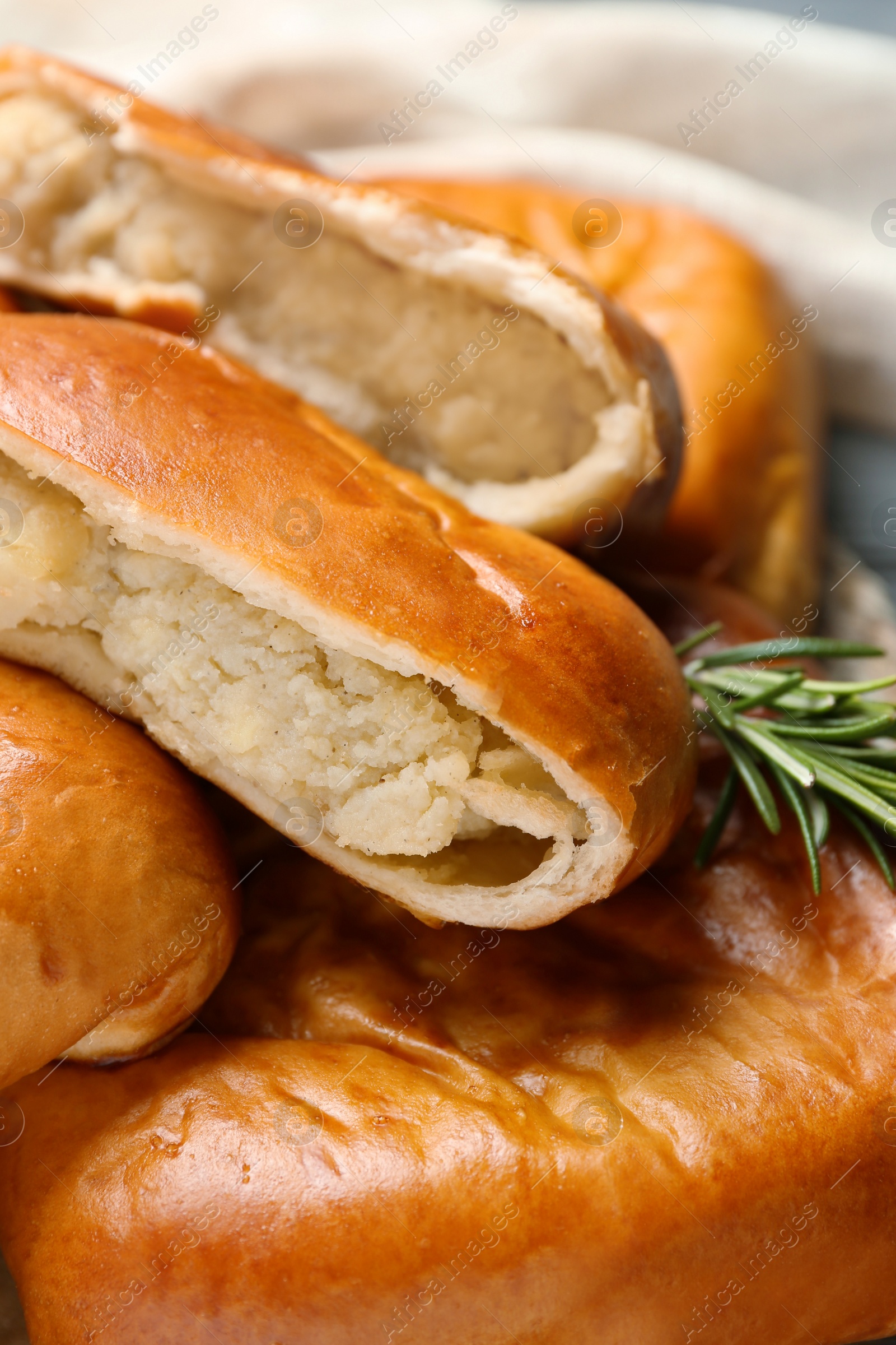 Photo of Many delicious baked patties on table, closeup