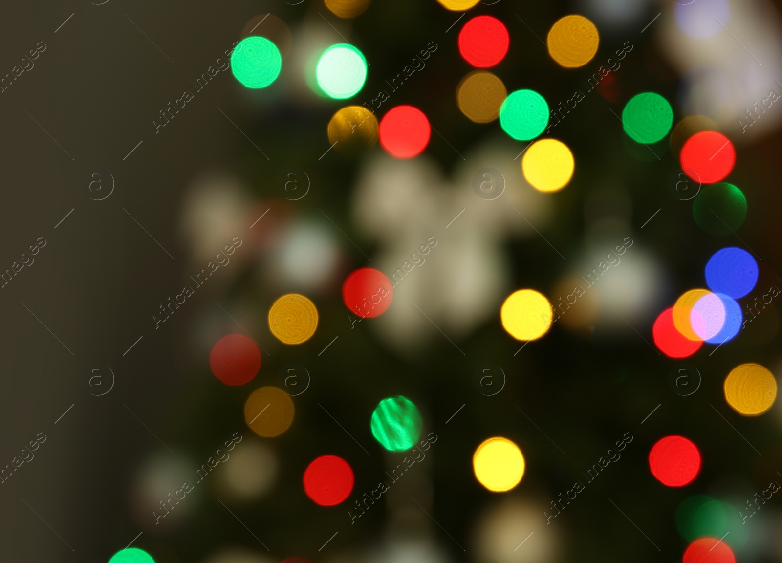 Photo of Blurred view of Christmas tree decorated with glowing lights