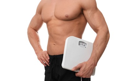 Photo of Athletic man holding scales on white background, closeup. Weight loss concept