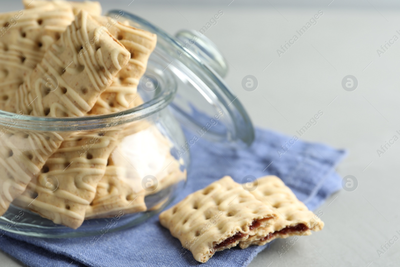 Photo of Tasty cookies with filling on light grey table, closeup