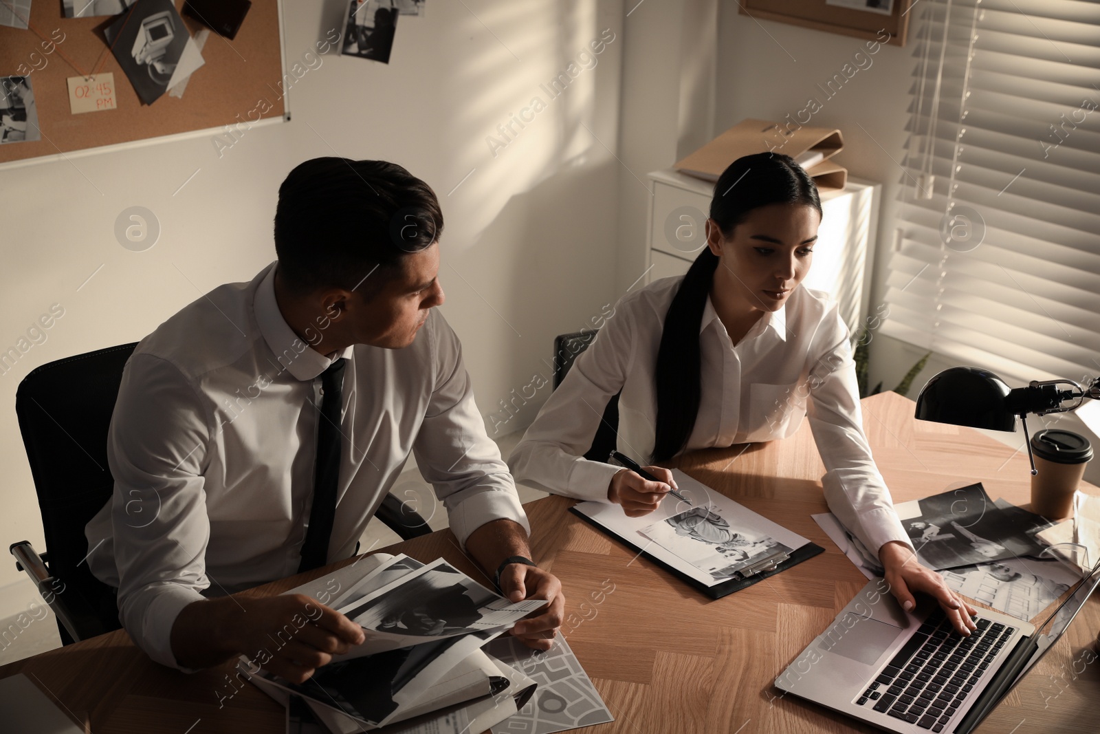 Photo of Professional detectives working at desk in office