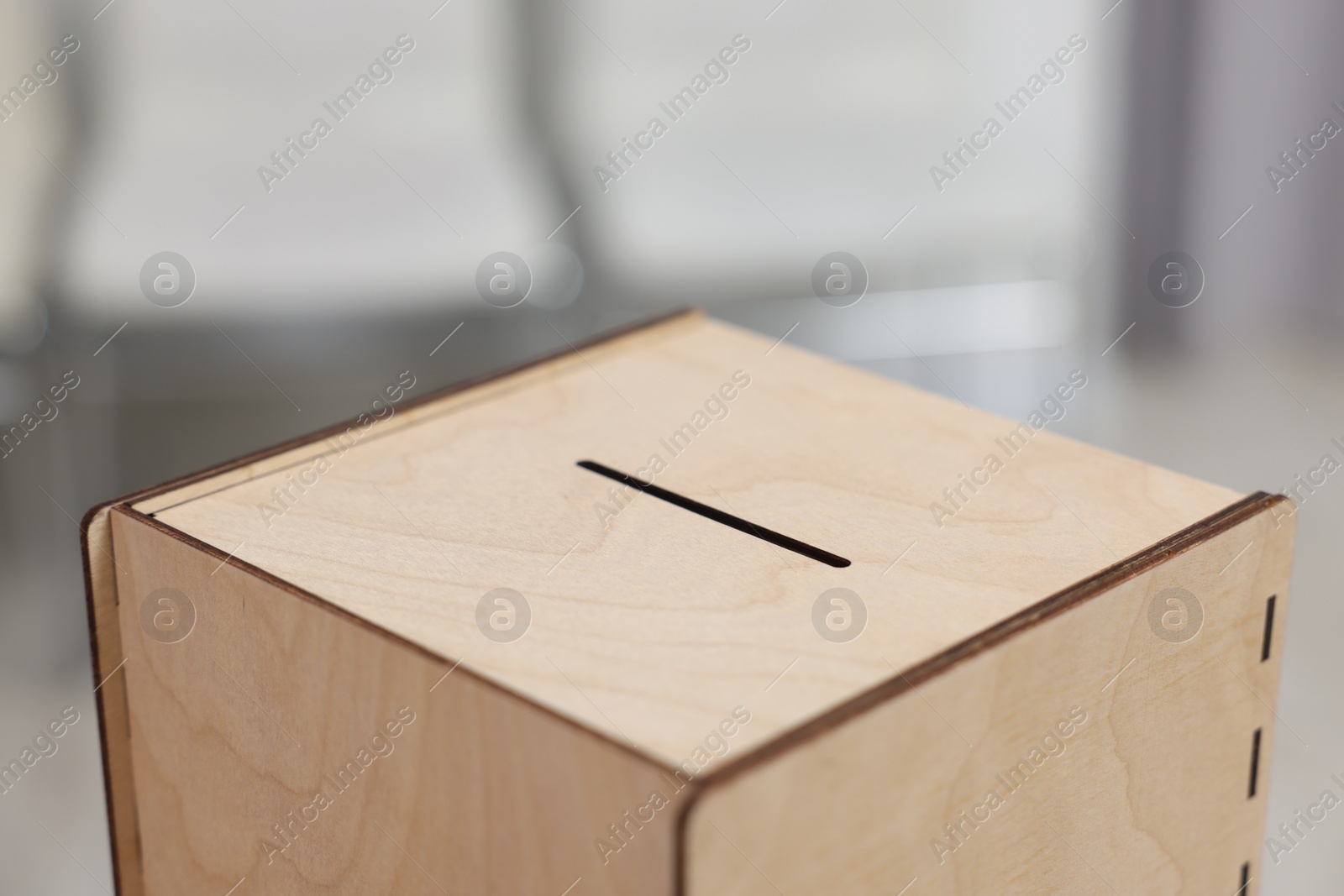 Photo of Wooden ballot box on blurred background, closeup