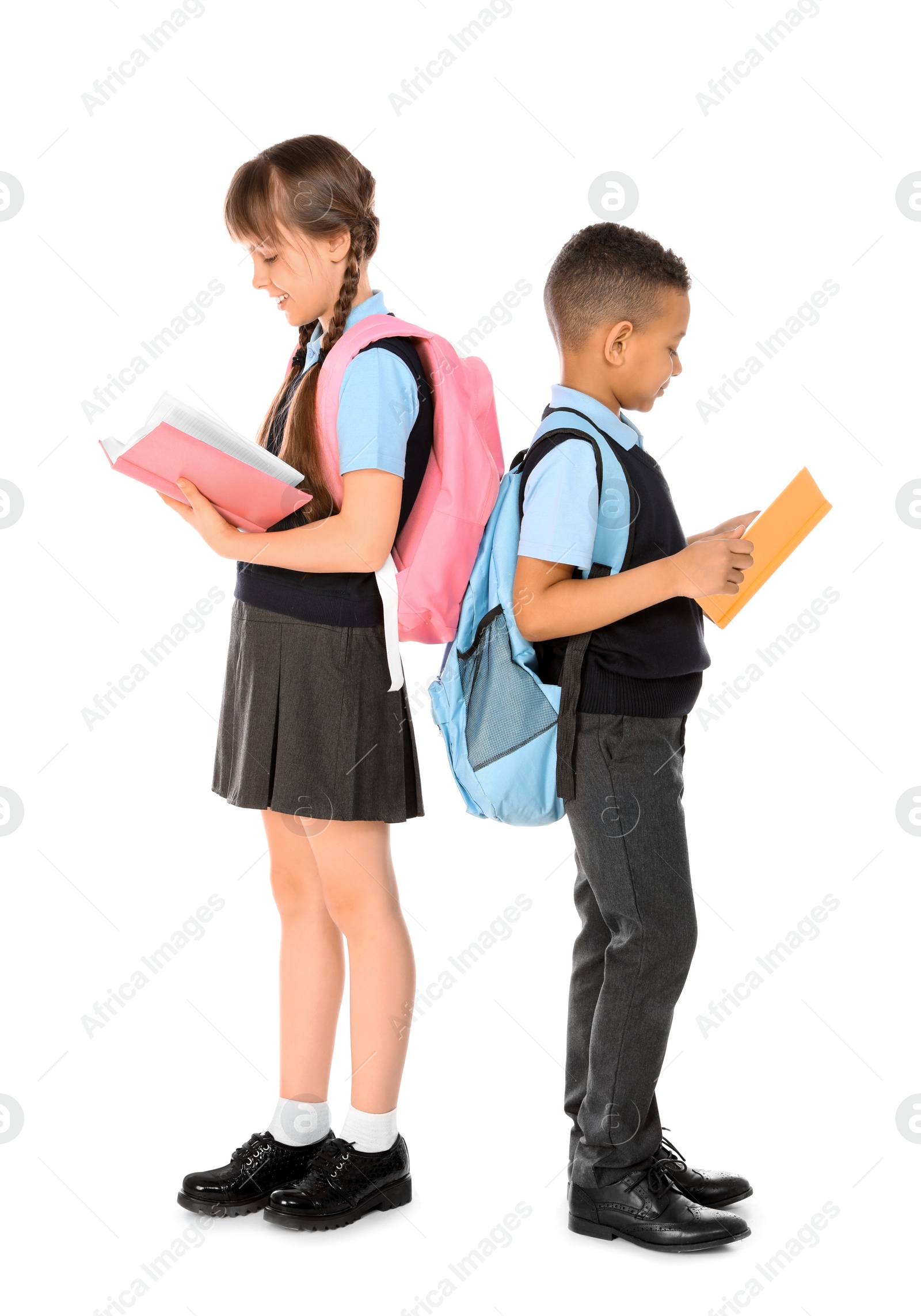 Photo of Full length portrait of cute children in school uniform on white background