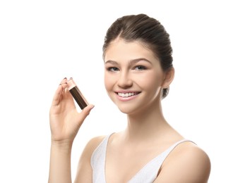 Photo of Beautiful girl with stick foundation on white background