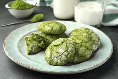 Plate with tasty matcha cookies on grey table
