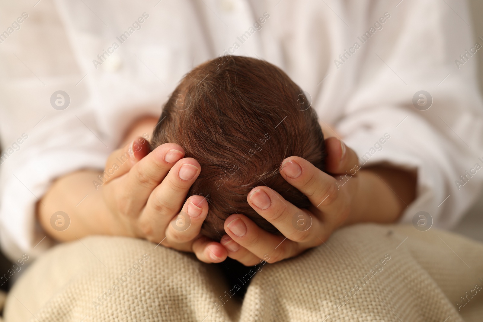 Photo of Mother holding her newborn baby, closeup view