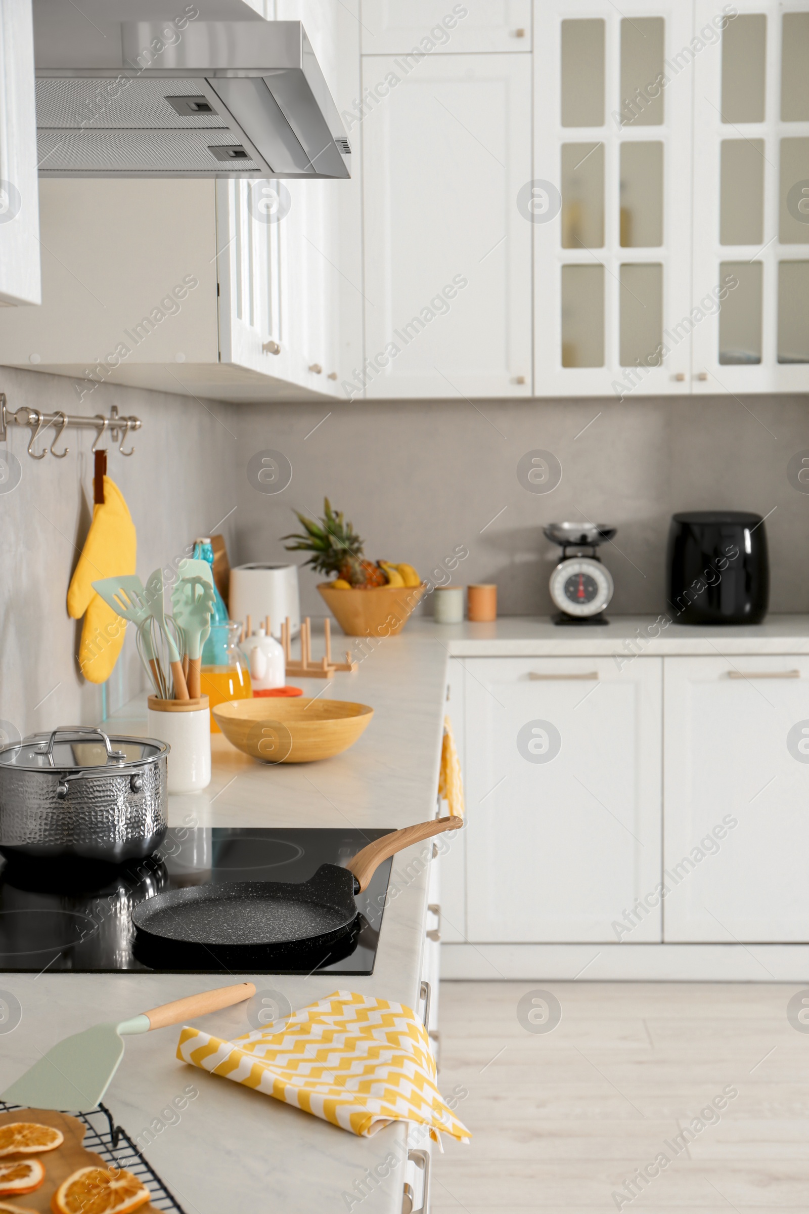 Photo of Modern cooktop and stylish furniture in kitchen