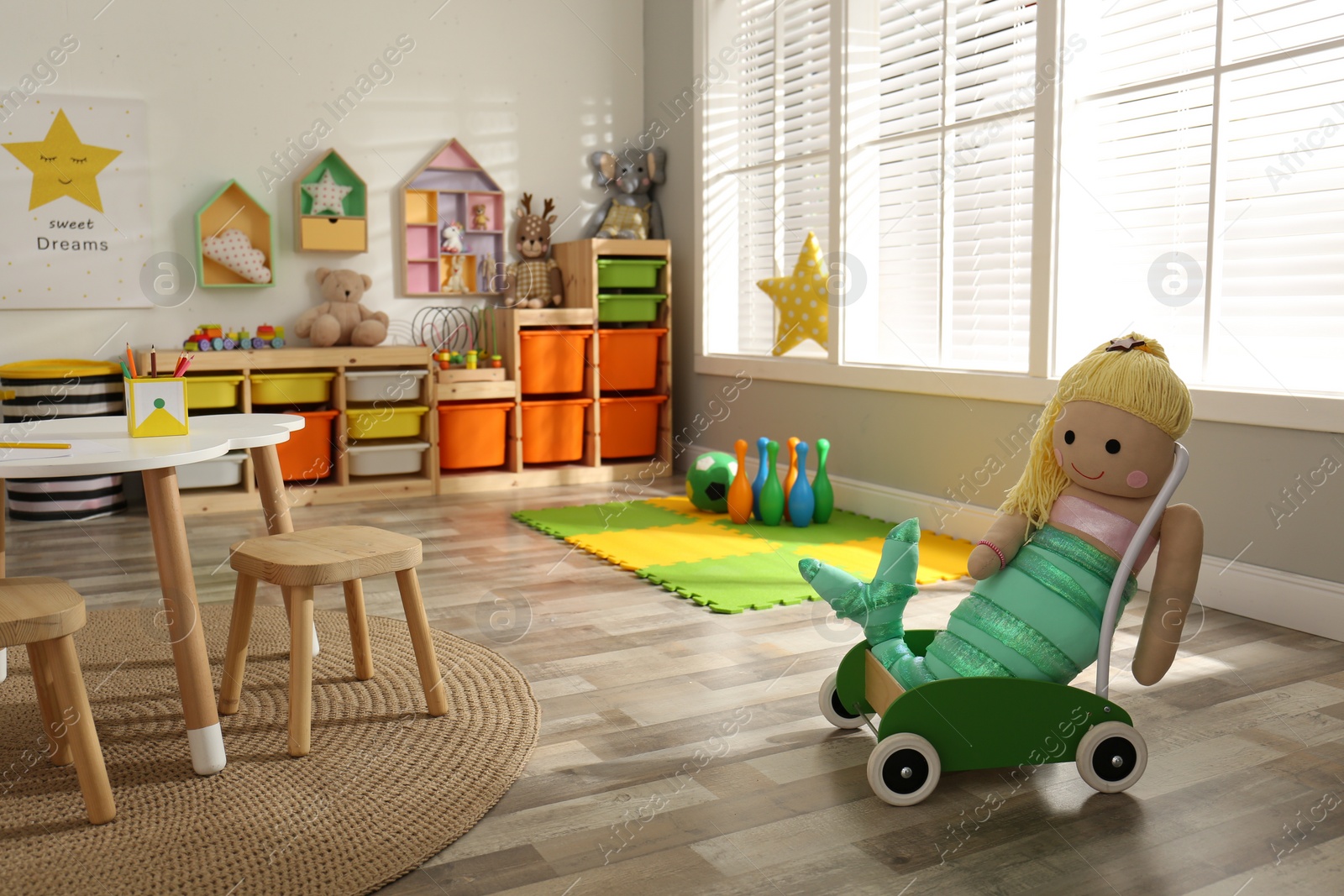 Photo of Stylish playroom interior with soft toys and modern furniture