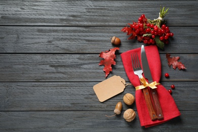 Flat lay composition with cutlery and autumn decoration on grey wooden background, space for text. Happy Thanksgiving day