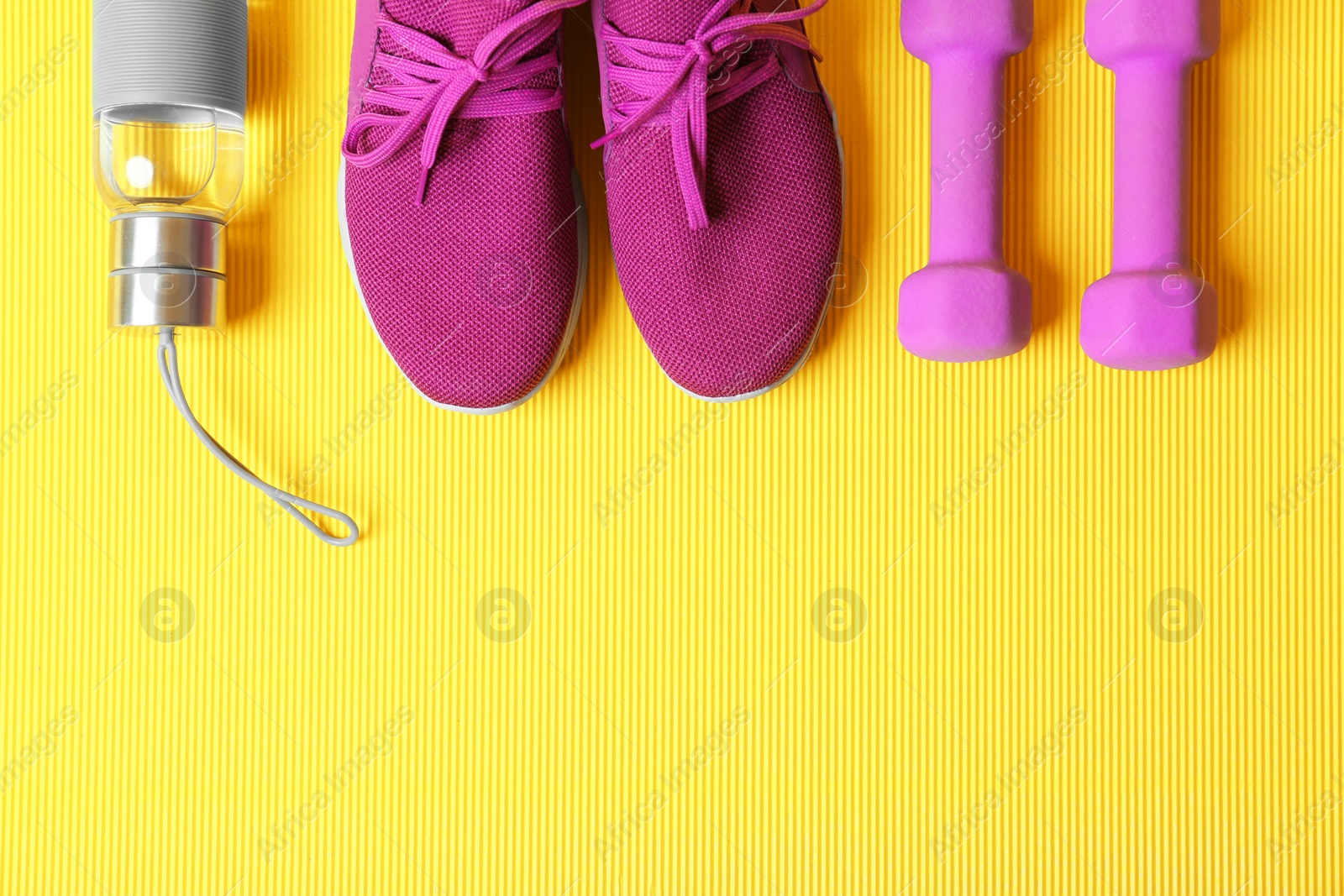 Photo of Flat lay composition with fitness equipment and space for text on color background