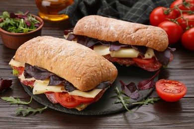 Photo of Delicious sandwiches with cheese, salami, tomato on wooden table