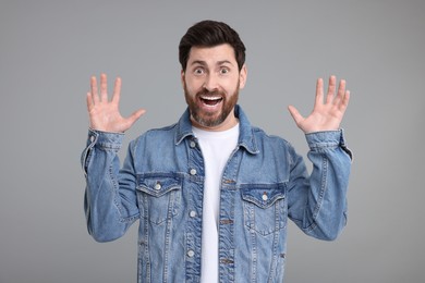 Photo of Portrait of surprised man on grey background