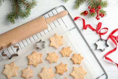 Photo of Tasty homemade Christmas cookies on baking parchment, top view