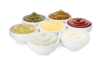 Photo of Many different sauces in bowls on white background