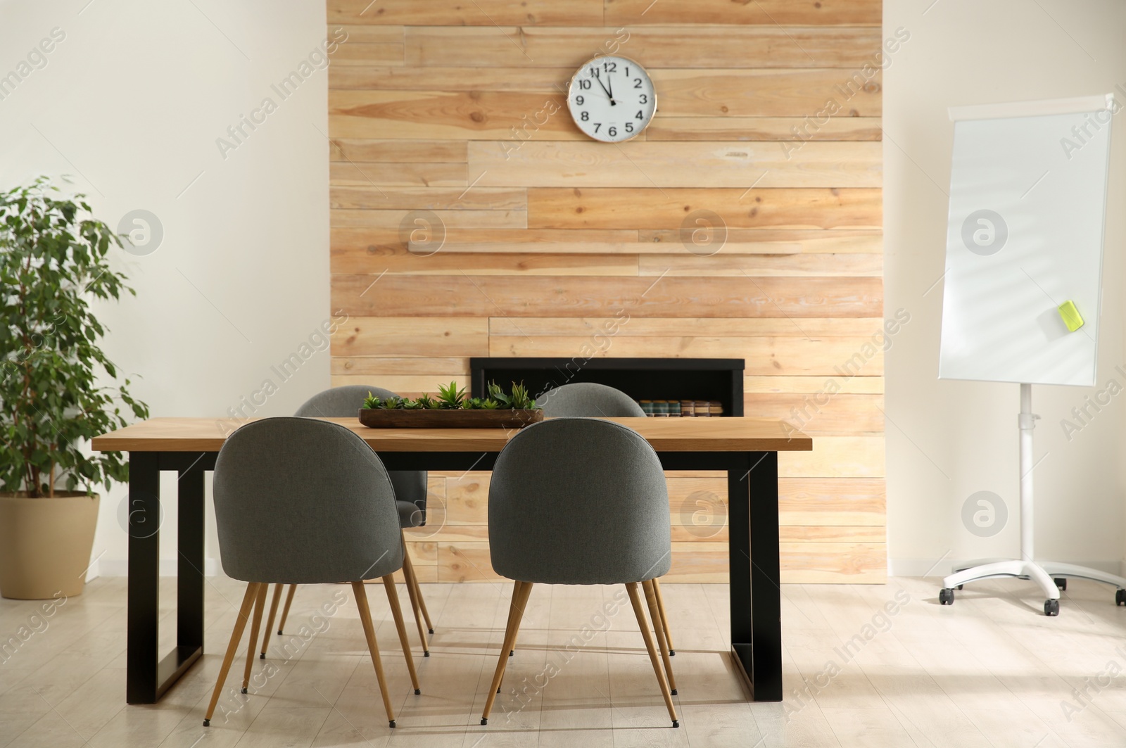 Photo of Modern meeting room interior with large table and chairs