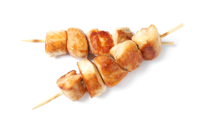 Photo of Delicious chicken shish kebabs on white background