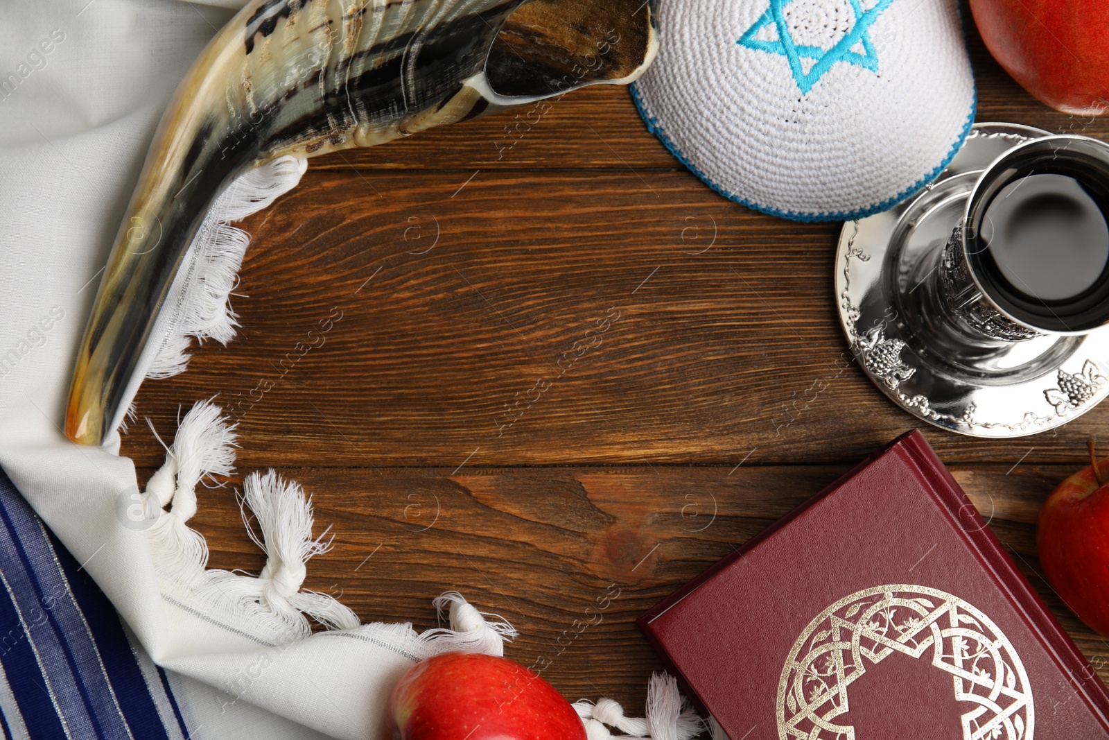 Photo of Frame of Rosh Hashanah holiday attributes on wooden table, flat lay. Space for text