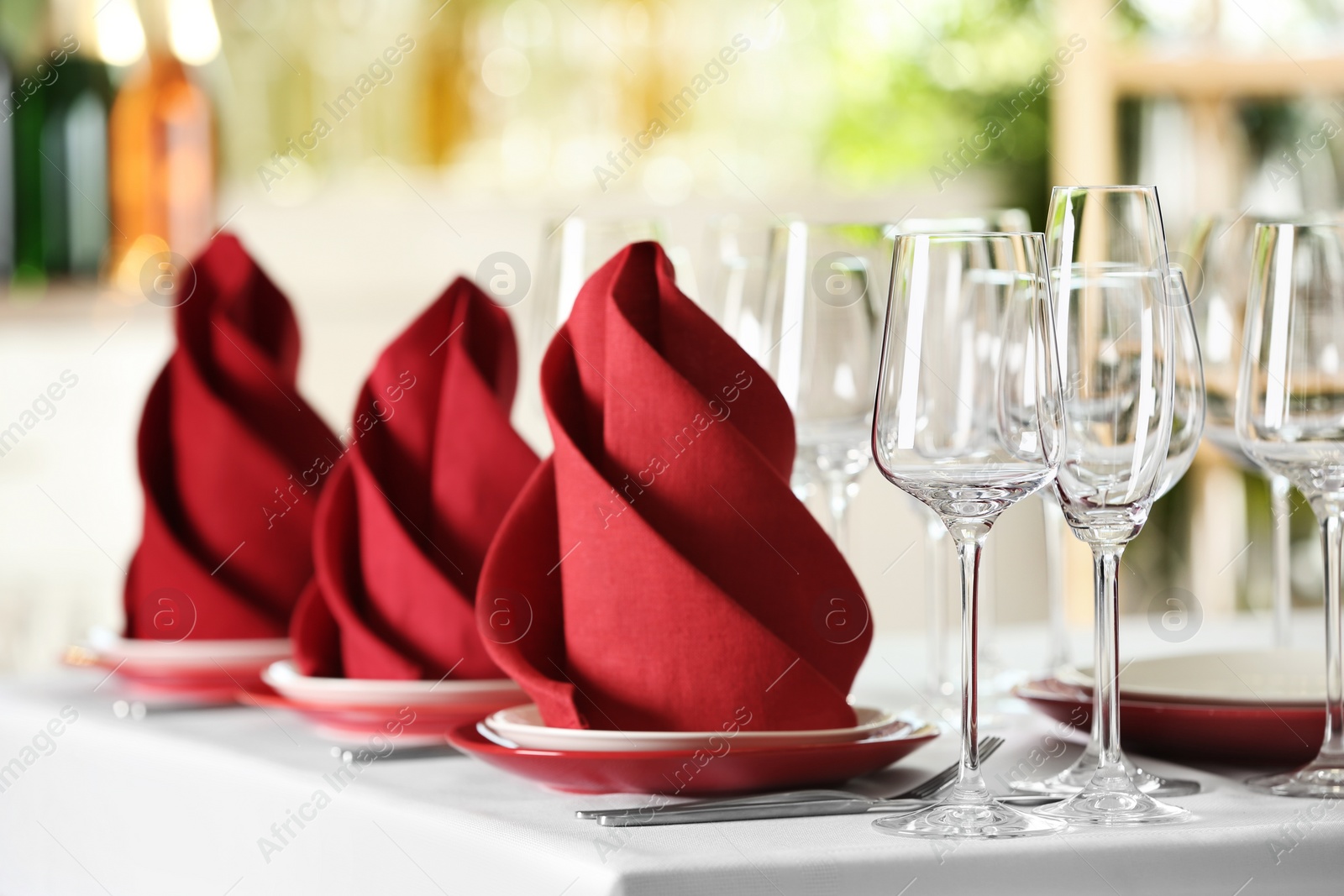 Photo of Table setting with empty glasses, plates and cutlery on table