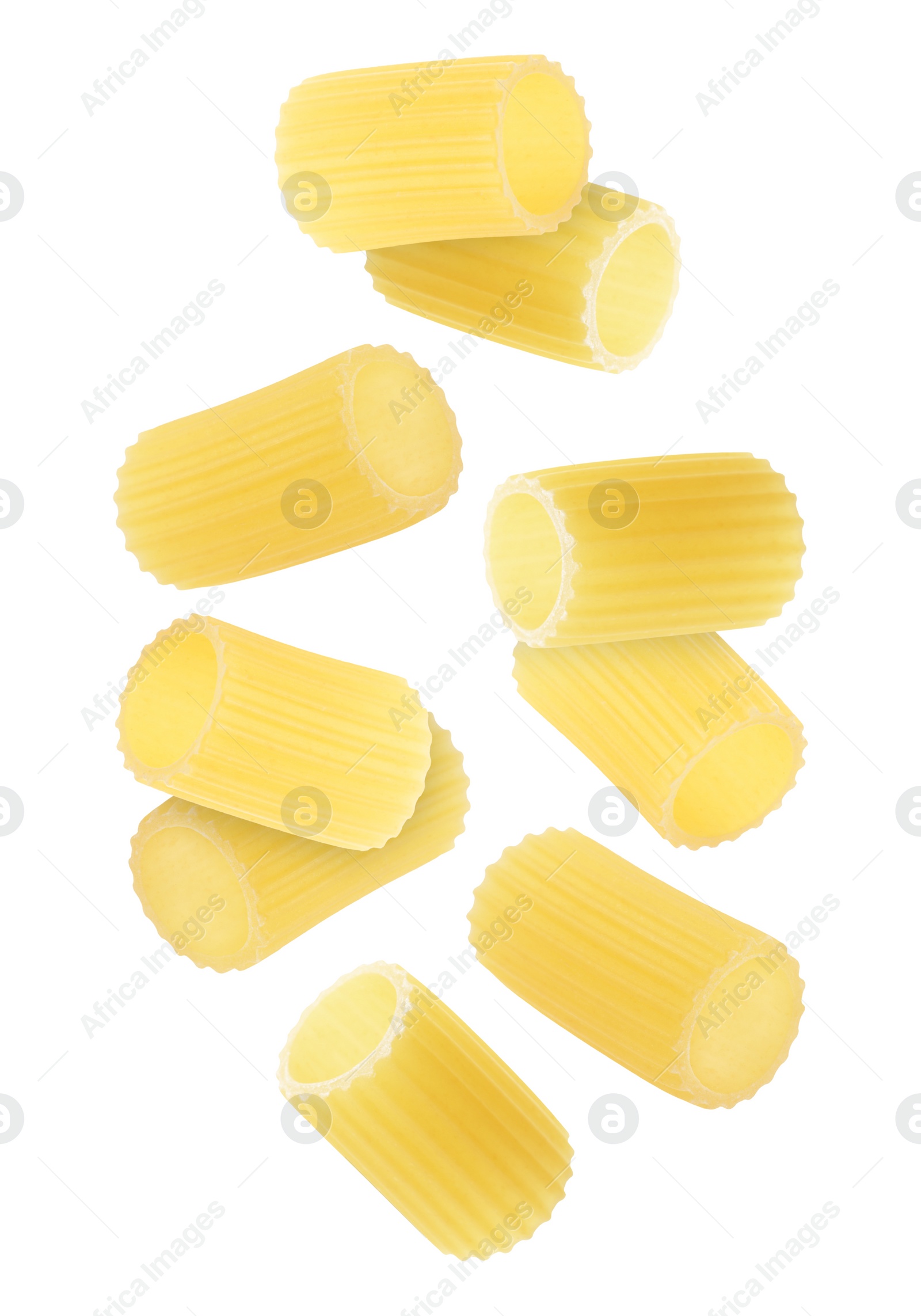 Image of Raw rigatoni pasta falling on white background