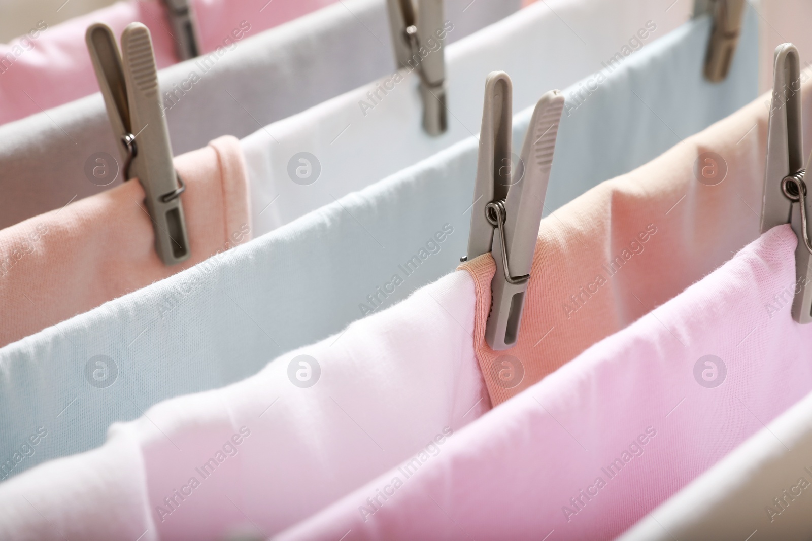 Photo of Clean laundry hanging on drying rack, closeup