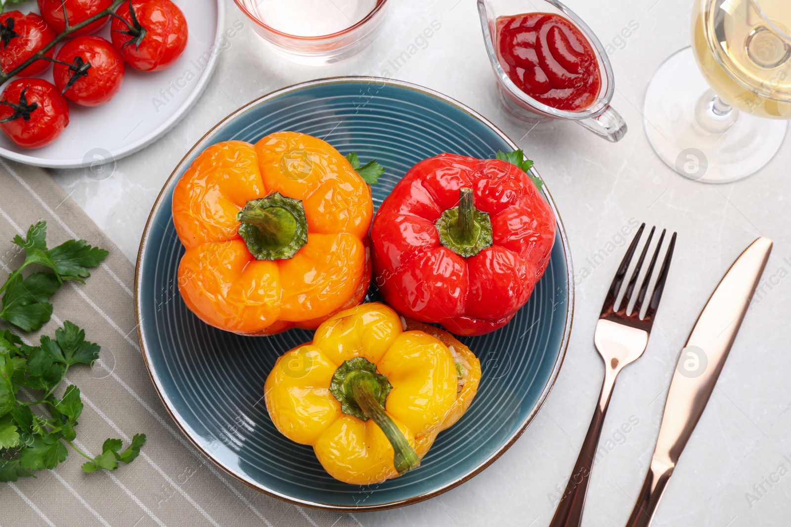 Photo of Tasty stuffed bell peppers served on light table, flat lay