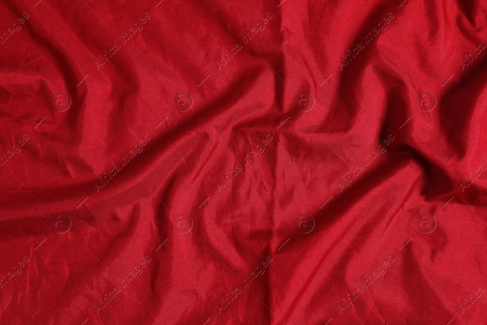 Photo of Crumpled dark red fabric as background, top view