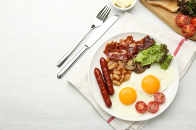 Photo of Delicious breakfast with sunny side up eggs served on white table, flat lay. Space for text