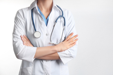 Photo of Doctor with stethoscope on white background, closeup. Medical service