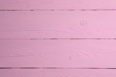 Texture of pink wooden surface as background, closeup