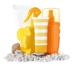 Photo of Different suntan products and stones on white background