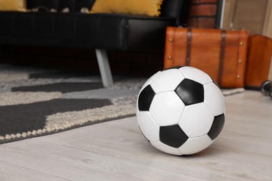 Photo of Soccer ball in stylish teenager's room. Space for text