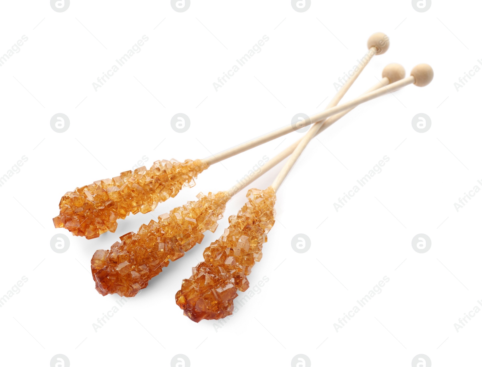 Photo of Wooden sticks with sugar crystals isolated on white. Tasty rock candies