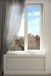 Image of Beautiful view of bushes and sea through window